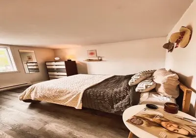 a bedroom with a bed and a table at House 5 bedrooms - close to metro in Montréal