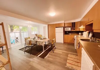 a kitchen and dining room with a table with chairs at House 5 bedrooms - close to metro in Montréal
