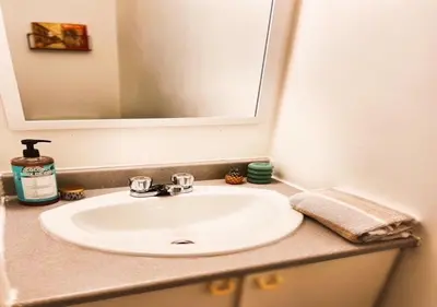 a bathroom counter with a sink and a mirror at House 5 bedrooms - close to metro in Montréal
