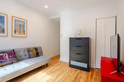 a living room with a couch and a dresser at Charming 2BR in Plateau Mont-Royal in Montréal