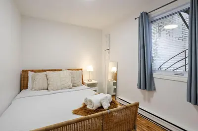 a bedroom with a bed and a window at Charming 2BR in Plateau Mont-Royal in Montréal