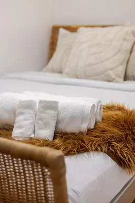 two beds with white pillows and a brown blanket at Charming 2BR in Plateau Mont-Royal in Montréal