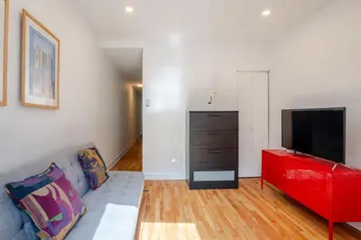 a living room with a couch and a flat screen tv at Charming 2BR in Plateau Mont-Royal in Montréal