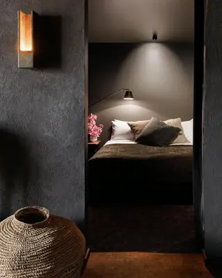 a bedroom with a bed and a lamp and some pillows at Maison Grinder in Montréal