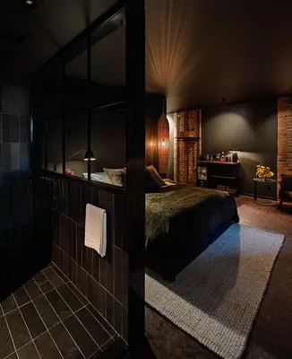 a bedroom with a bed and a glass wall at Maison Grinder in Montréal