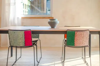 a table with three chairs with a vase on top at Bel appartement confortable - Emplacement idéal in Montréal