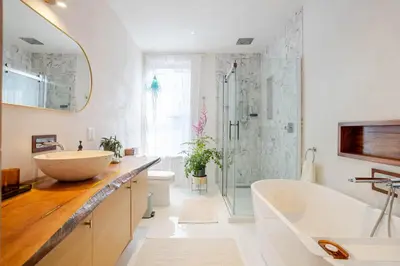 a bathroom with a tub and a sink and a shower at Bel appartement confortable - Emplacement idéal in Montréal