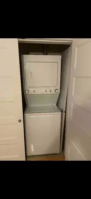 a white refrigerator with its door open in a kitchen at Condo spacieux in Montréal