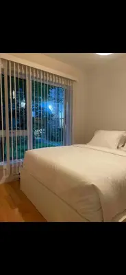 a bedroom with a large bed and a window at Condo spacieux in Montréal
