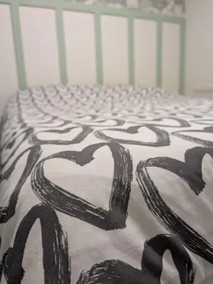 a bed with two hearts painted on it at Espace Cozy - 2 bed in Longueuil