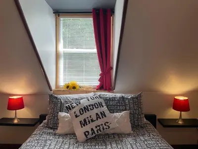 a bedroom with a bed with pillows and a window at Auberge La Table d'Hôte in West Brome