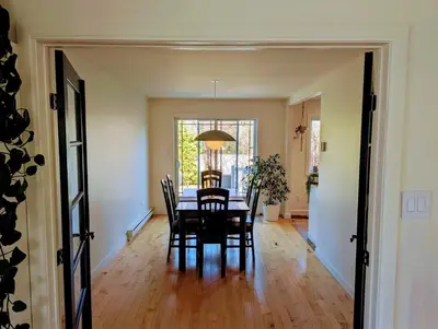a dining room with a table and chairs at Fully furnished cozy home in Montréal