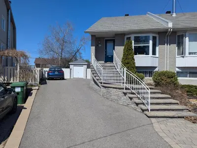 a house with stairs leading to a driveway at Fully furnished cozy home in Montréal