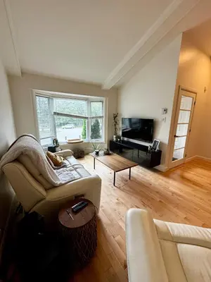 a living room with a couch and a table at Fully furnished cozy home in Montréal