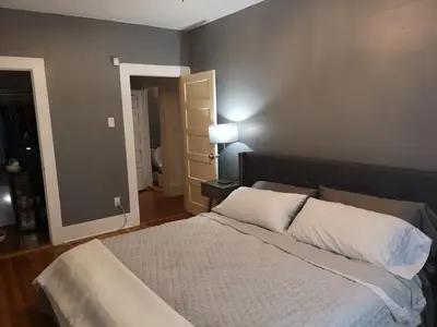 a bedroom with a large bed with white pillows at Huge King Room in 3 BedRoom Great Location Downtown Mtl in Montréal
