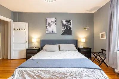 a bedroom with a large bed with two night stands at Huge King Room in 3 BedRoom Great Location Downtown Mtl in Montréal