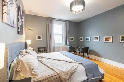 a bedroom with a large bed and a window at Huge King Room in 3 BedRoom Great Location Downtown Mtl in Montréal