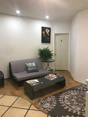 a living room with a couch and a coffee table at Montreal Accommodation Steps Downtown 17mins airport in Montréal