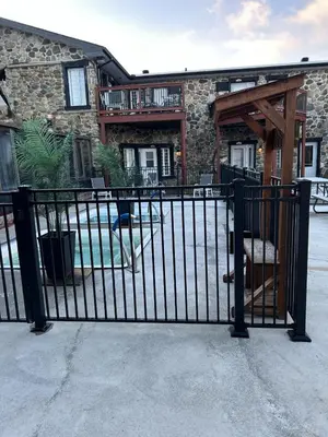 a black metal gate in front of a building at Le loft Orford Magog in Magog-Orford