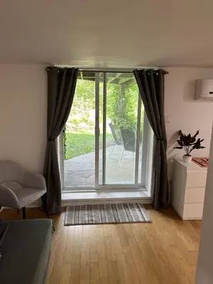 a living room with a sliding glass door at Le loft Orford Magog in Magog-Orford