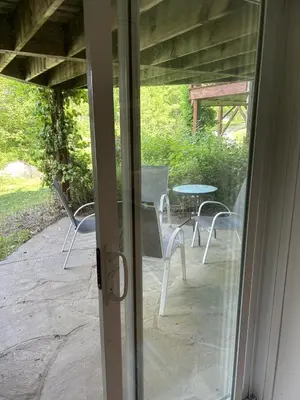 a sliding glass door with a table and chairs outside at Le loft Orford Magog in Magog-Orford