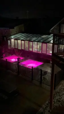 a building with pink lights in front of it at night at Le loft Orford Magog in Magog-Orford