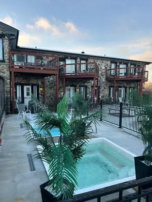 a house with a swimming pool in front of a building at Le loft Orford Magog in Magog-Orford