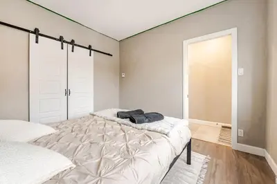 a bedroom with a large bed and a sliding door at Bohemian vibe 2 bedroom Free Parking Brand New in Montréal