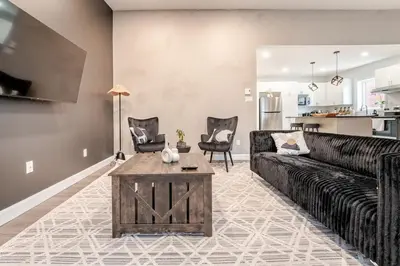 a living room with a couch and a table at Bohemian vibe 2 bedroom Free Parking Brand New in Montréal