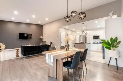 a kitchen and living room with a table and chairs at Bohemian vibe 2 bedroom Free Parking Brand New in Montréal
