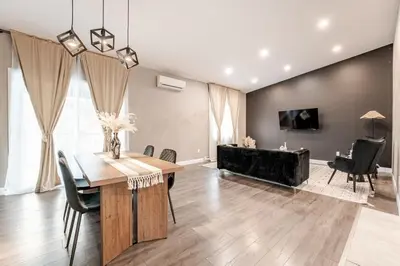 a dining room with a table and chairs and a couch at Bohemian vibe 2 bedroom Free Parking Brand New in Montréal