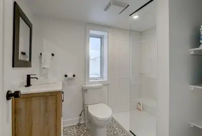 a bathroom with a toilet and a sink and a shower at room with shared bathrooms 883 Shefford in Bromont
