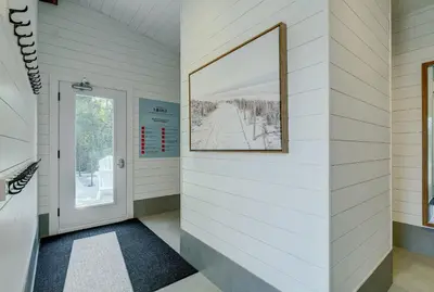 a hallway with a door and a picture on the wall at room with shared bathrooms 883 Shefford in Bromont