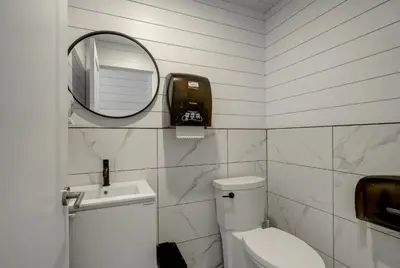 a bathroom with a toilet and a mirror and a sink at room with shared bathrooms 883 Shefford in Bromont