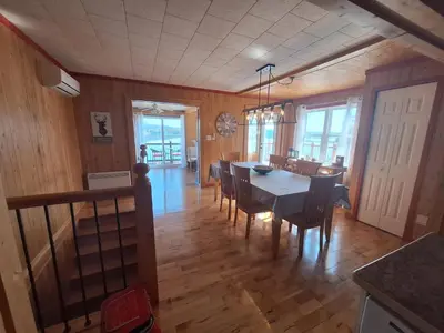 a kitchen and dining room with a table and chairs at Le Repos Du Lac Aylmer in Disraeli