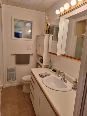 a bathroom with a sink and a toilet at Le Repos Du Lac Aylmer in Disraeli