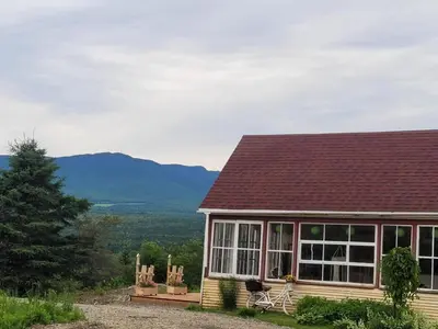 a house with a view of a mountain at Gîte champêtre Chesham in Notre-Dame-Des-Bois
