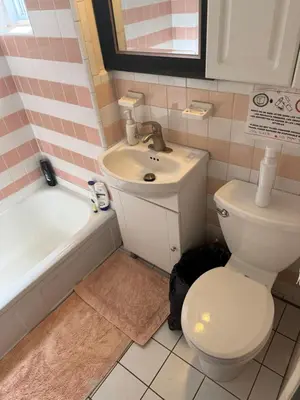 a bathroom with a toilet and a sink and a tub at Montréal Downtown Private Rooms Across Polytechnique in Montréal