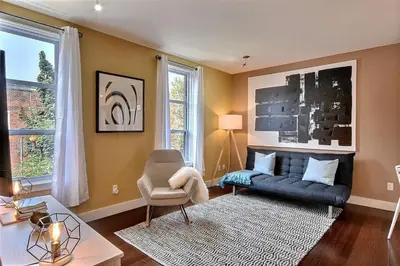 a living room with a couch and a chair at Sacha's Home Away in Quiet Montreal in Montréal