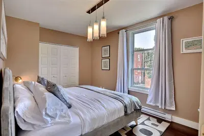 a bedroom with a bed and a window at Sacha's Home Away in Quiet Montreal in Montréal