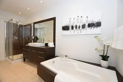 a bathroom with a large bath tub and a shower at Ground Floor Loft Style Luxury Executive Flat in Montréal