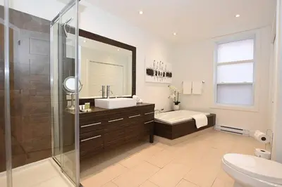 a bathroom with a shower and a sink and a toilet at Ground Floor Loft Style Luxury Executive Flat in Montréal