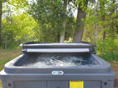 a grill with water in it in a park at Chalet Le Mignon Nature Escape & Comfort in Saint Ambroise de Kildare