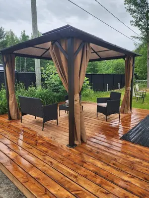 a gazebo with chairs and tables on a wooden deck at Chalet Le Mignon Nature Escape & Comfort in Saint Ambroise de Kildare