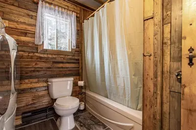 a bathroom with a toilet and a tub and a sink at Chalet Le Mignon Nature Escape & Comfort in Saint Ambroise de Kildare