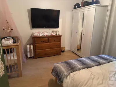 a bedroom with a flat screen tv on a dresser at la voyageuse in Longueuil