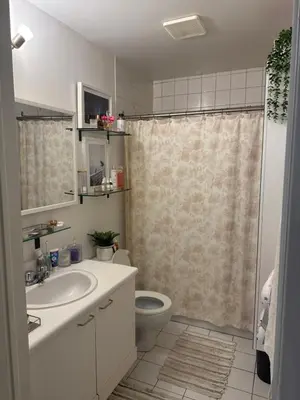 a bathroom with a toilet and a sink and a shower at la voyageuse in Longueuil
