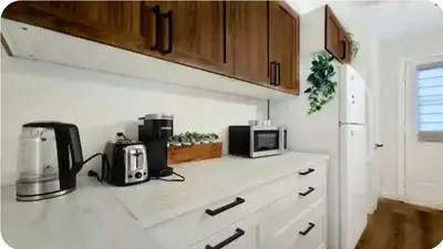 a kitchen counter with a coffee maker and a microwave at Boho style Private rooms in a shared three rooms apartment in Montréal