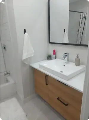 a bathroom with a sink and a mirror and a tub at Boho style Private rooms in a shared three rooms apartment in Montréal