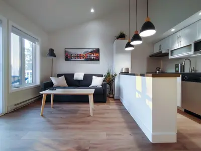 a living room with a couch and a table at Chalet Tranquillité Orford in Magog-Orford